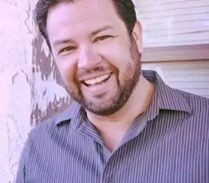 Person smiling in casual striped shirt