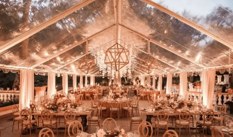 Elegant outdoor wedding reception under tent canopy.