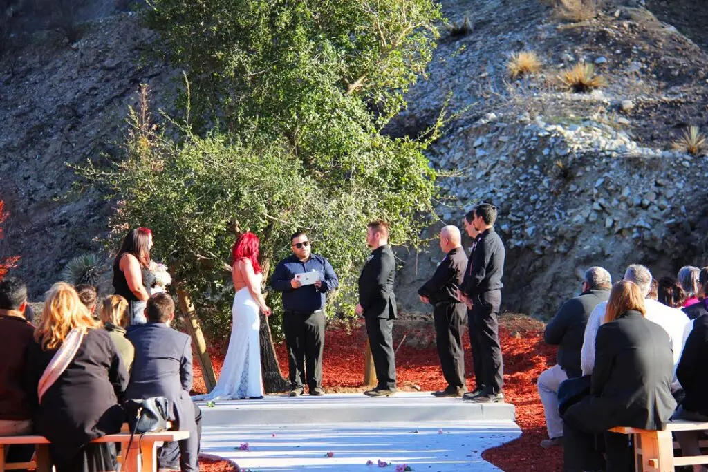 Outdoor wedding ceremony with guests seated