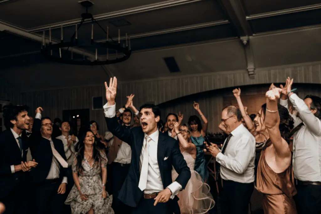 People dancing joyfully at a celebration event.