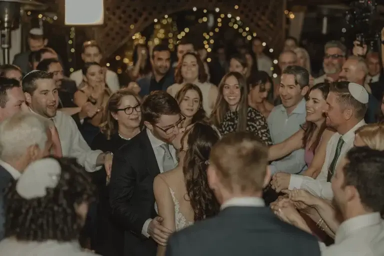 Crowd celebrating at a wedding reception.