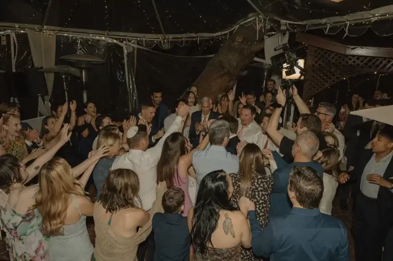 Crowd celebrating indoors at a party.